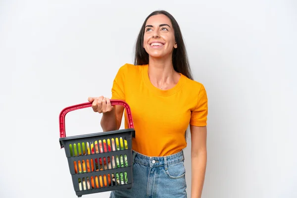 Young Caucasian Woman Holding Shopping Basket Full Food Isolated White — Φωτογραφία Αρχείου