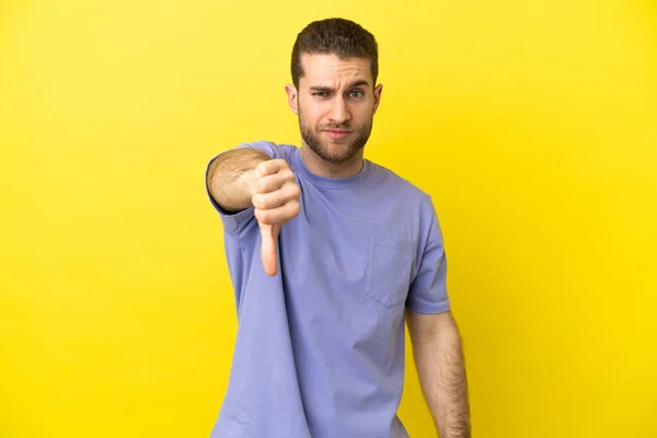 Hombre Guapo Rubio Sobre Fondo Amarillo Aislado Mostrando Pulgar Hacia —  Fotos de Stock