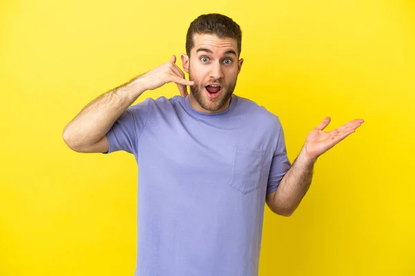 Handsome Blonde Man Isolated Yellow Background Making Phone Gesture Doubting — Φωτογραφία Αρχείου