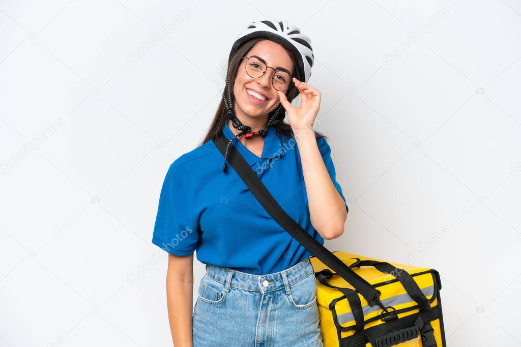 Young caucasian woman with thermal backpack isolated on white background with glasses and happy