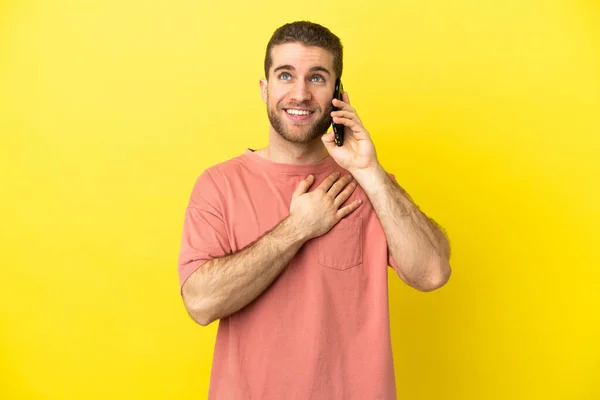 Handsome Blonde Man Using Mobile Phone Isolated Background Looking While — Stock Photo, Image
