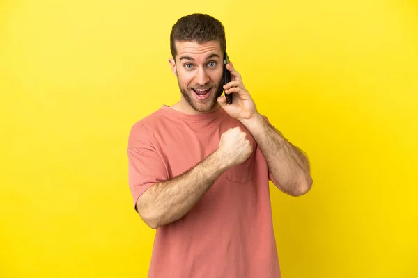 Handsome Blonde Man Using Mobile Phone Isolated Background Celebrating Victory — Stock Photo, Image