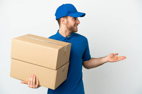 Delivery man over isolated white background with surprise expression while looking side