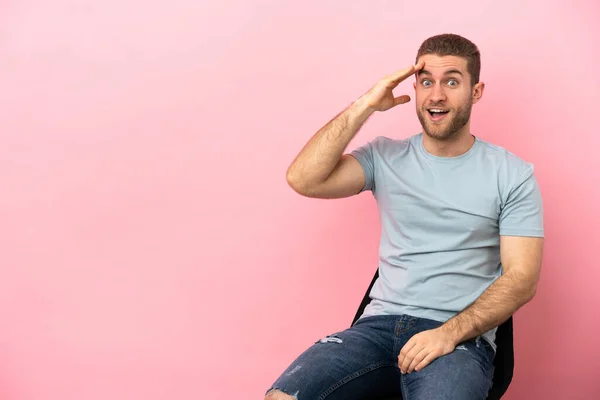 Young Man Sitting Chair Isolated Pink Background Has Realized Something — Stockfoto