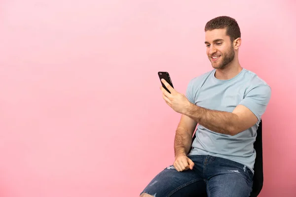 Young Man Sitting Chair Isolated Pink Background Making Selfie — Φωτογραφία Αρχείου