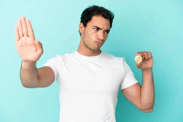 Young Man Holding Bitcoin Isolated Blue Background Making Stop Gesture — Φωτογραφία Αρχείου