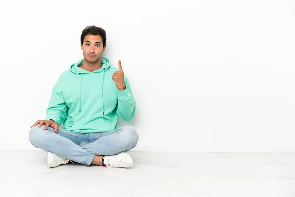 Caucasian Handsome Man Sitting Floor Pointing Index Finger Great Idea — Stok fotoğraf