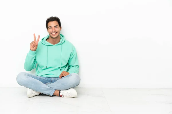 Caucasian Handsome Man Sitting Floor Smiling Showing Victory Sign — Φωτογραφία Αρχείου