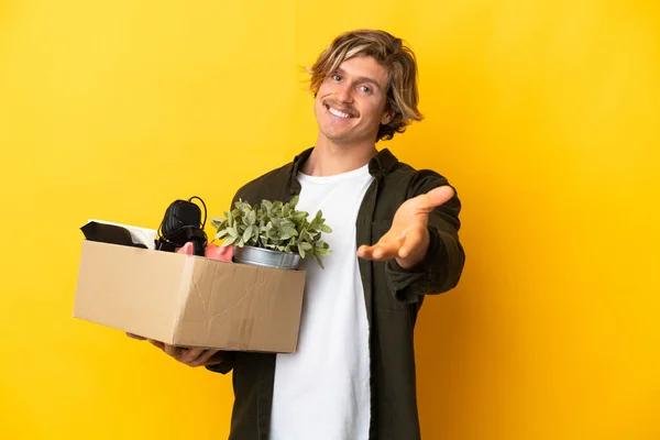 Blonde Man Making Move While Picking Box Full Things Isolated — Φωτογραφία Αρχείου