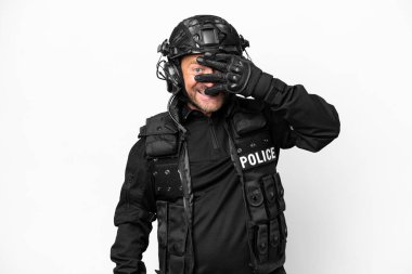 Middle age SWAT man isolated on white background covering eyes by hands and smiling