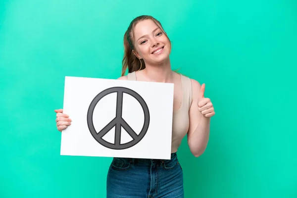 Young Caucasian Woman Isolated Green Background Holding Placard Peace Symbol — Fotografia de Stock