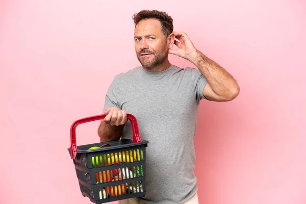 Middle Age Caucasian Man Holding Shopping Basket Isolated Pink Background — 图库照片