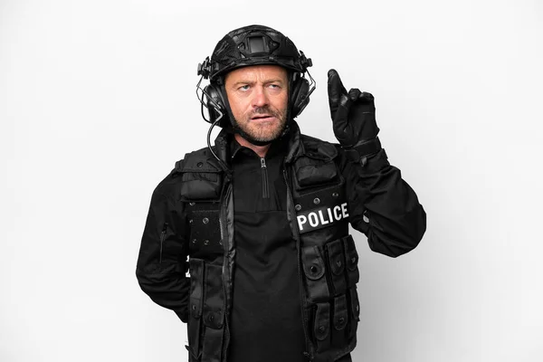 stock image Middle age SWAT man isolated on white background with fingers crossing and wishing the best