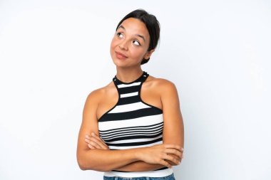 Young hispanic woman isolated on white background thinking an idea while looking up