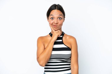 Young hispanic woman isolated on white background and thinking