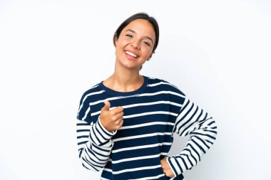 Young hispanic woman isolated on white background with thumbs up because something good has happened