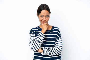 Young hispanic woman isolated on white background having doubts