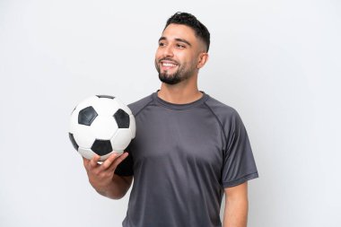 Arab young football player man isolated on white background thinking an idea while looking up
