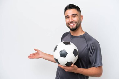 Arab young football player man isolated on white background extending hands to the side for inviting to come