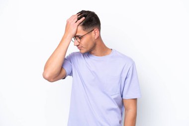Beyaz arka planda başı ağrıyan genç beyaz bir adam.