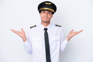 Airplane caucasian pilot isolated on white background having doubts while raising hands
