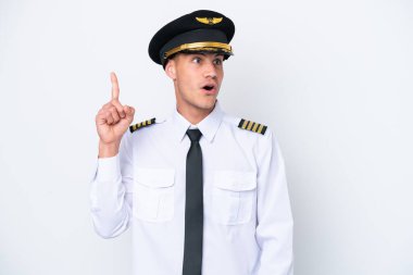 Airplane caucasian pilot isolated on white background intending to realizes the solution while lifting a finger up