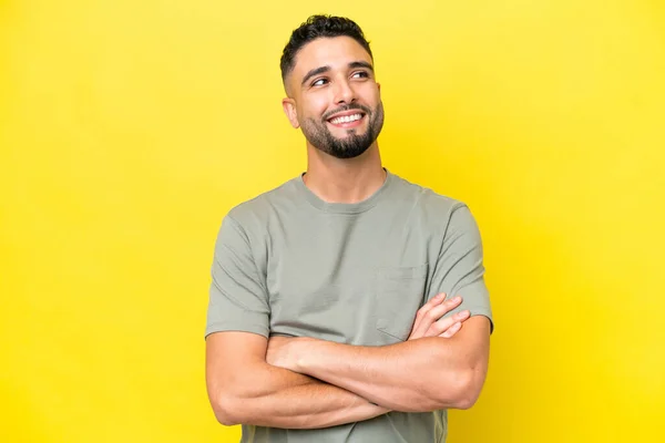 Young Arab Handsome Man Isolated Yellow Background Looking While Smiling — Stock fotografie
