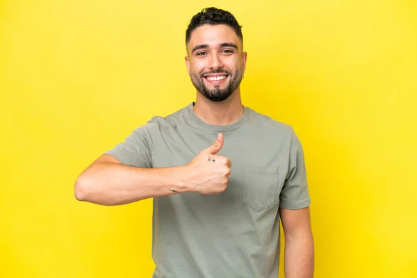 Young Arab Handsome Man Isolated Yellow Background Giving Thumbs Gesture — Foto de Stock
