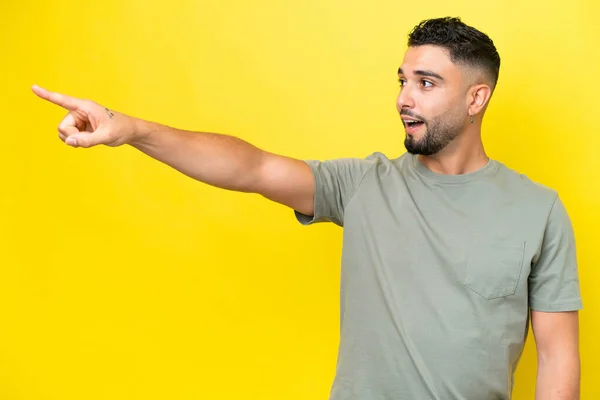Young Arab Handsome Man Isolated Yellow Background Pointing Away — Stockfoto