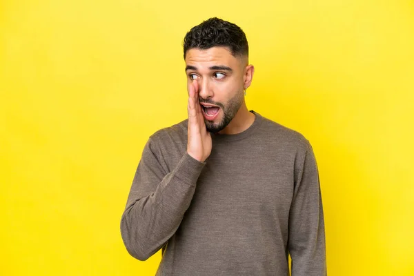 Young Arab Handsome Man Isolated Yellow Background Whispering Something Surprise — Stok fotoğraf