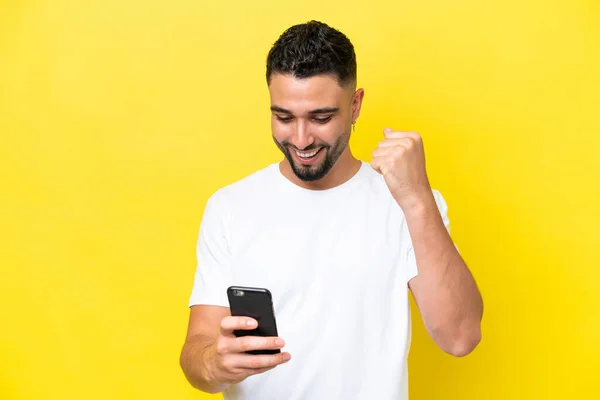 Young Arab Handsome Man Isolated Yellow Background Using Mobile Phone — Stok fotoğraf