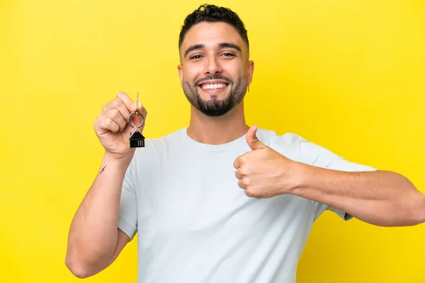 Young Arab Man Holding Home Keys Isolated Yellow Background Thumbs — Foto Stock