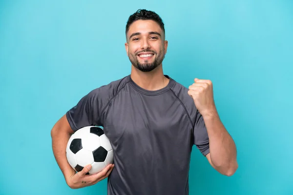 Young Arab Handsome Man Isolated Blue Background Soccer Ball Celebrating — Stock Photo, Image