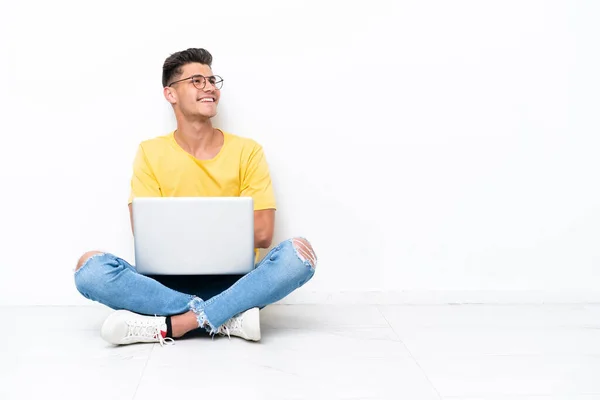 Young Man Sitting Floor Isolated White Background Looking While Smiling — 图库照片