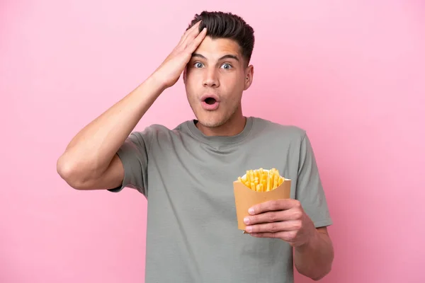 Young Caucasian Man Holding Fried Chips Isolated Pink Background Surprise — Fotografia de Stock