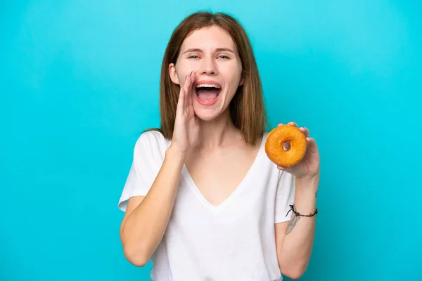 Young English Woman Holding Donut Isolated Blue Background Shouting Mouth — Stockfoto