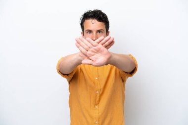Young man with moustache isolated on white background making stop gesture with her hand to stop an act