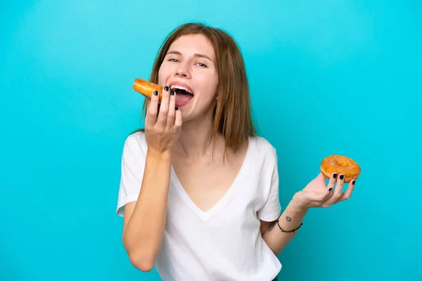 Young English Woman Isolated Blue Background Eating Donut — стоковое фото