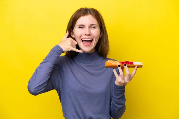 Young English Woman Holding Sashimi Isolated Yellow Background Making Phone — стоковое фото