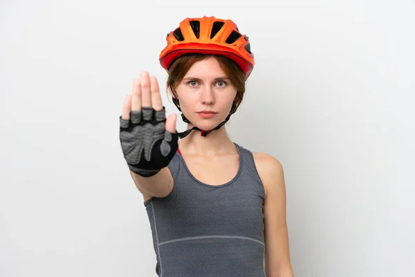Young cyclist English woman isolated on white background making stop gesture