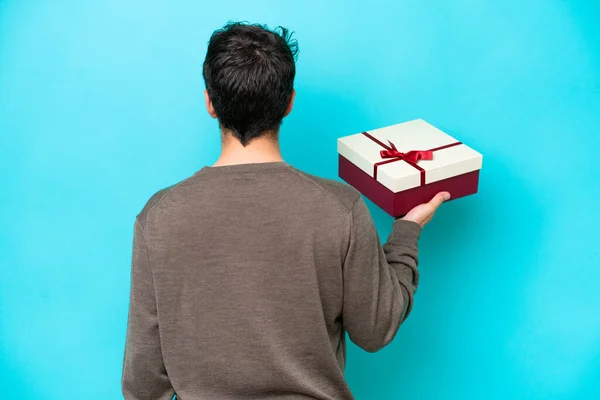 Young Man Holding Gift Back Position —  Fotos de Stock