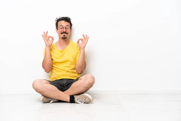 Young Caucasian Man Sitting Floor Isolated White Background Zen Pose — Fotografie, imagine de stoc