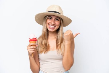 Young caucasian woman with a cornet ice cream isolated on white background pointing to the side to present a product