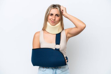 Woman with broken arm and wearing a sling isolated on white background having doubts