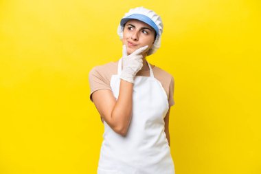 Fishwife woman over isolated background having doubts