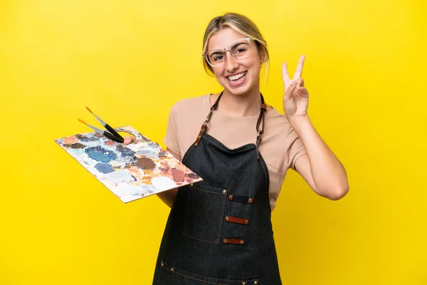 Young Artist Caucasian Woman Holding Palette Isolated Yellow Background Smiling — ストック写真