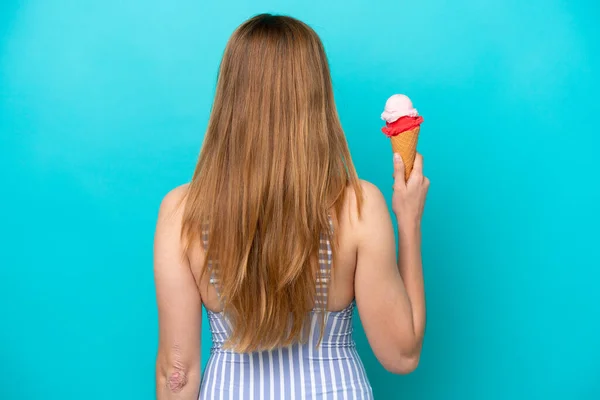 Young Caucasian Woman Swimsuit Eating Ice Cream Isolated Blue Background — Stockfoto