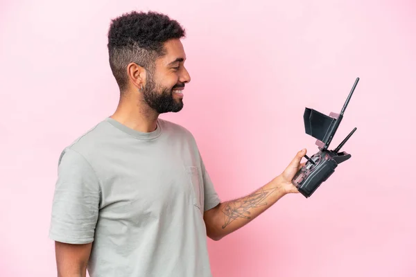 Brazilian Man Holding Drone Remote Control Isolated Pink Background Happy — 스톡 사진