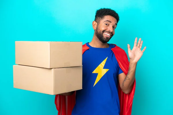 Super Hero Delivery Brazilian Man Isolated Blue Background Saluting Hand — Stock Photo, Image