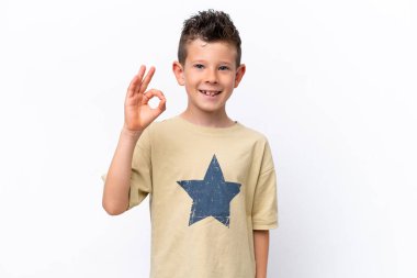 Beyaz arka planda izole edilmiş küçük beyaz çocuk parmaklarıyla tamam işareti gösteriyor.